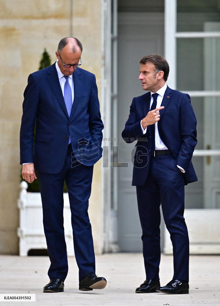 Macron and Merz Discuss in Elysee Garden - Paris