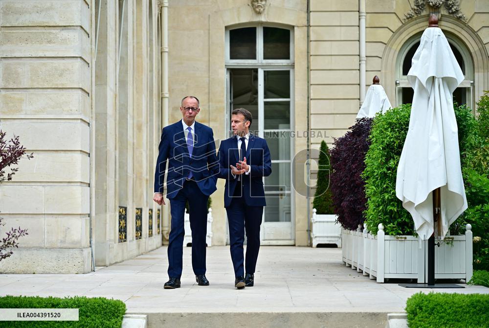Macron and Merz Discuss in Elysee Garden - Paris