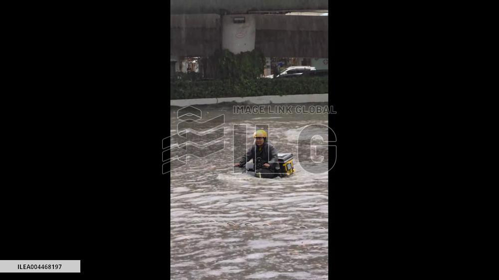 China: Delivery Worker in Wuhan Battles Waist-High Floodwater