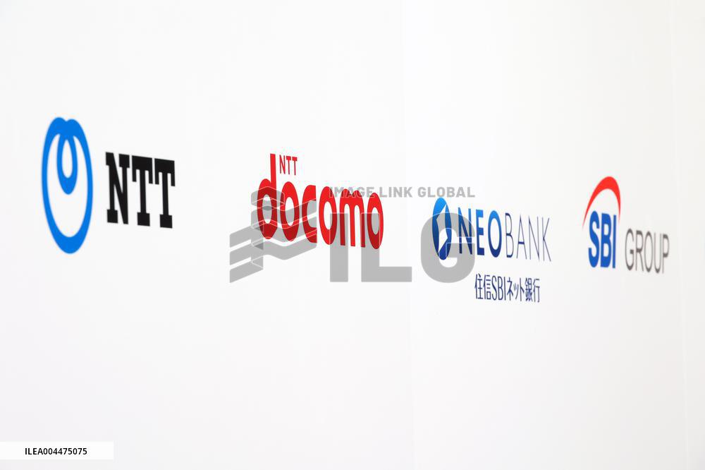 Signs and logos of NTT, NTT DoCoMo, SBI Sumishin Net Bank, and SBI Holdings