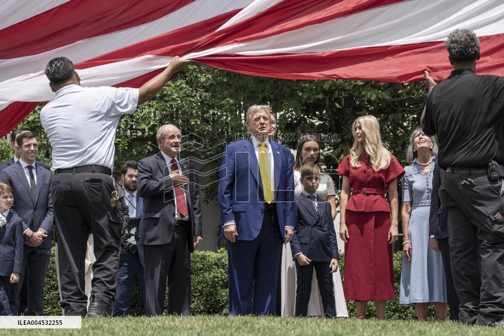 U.S. President Donald Trump Watches as the American Flag is Raised ont he South Lawn