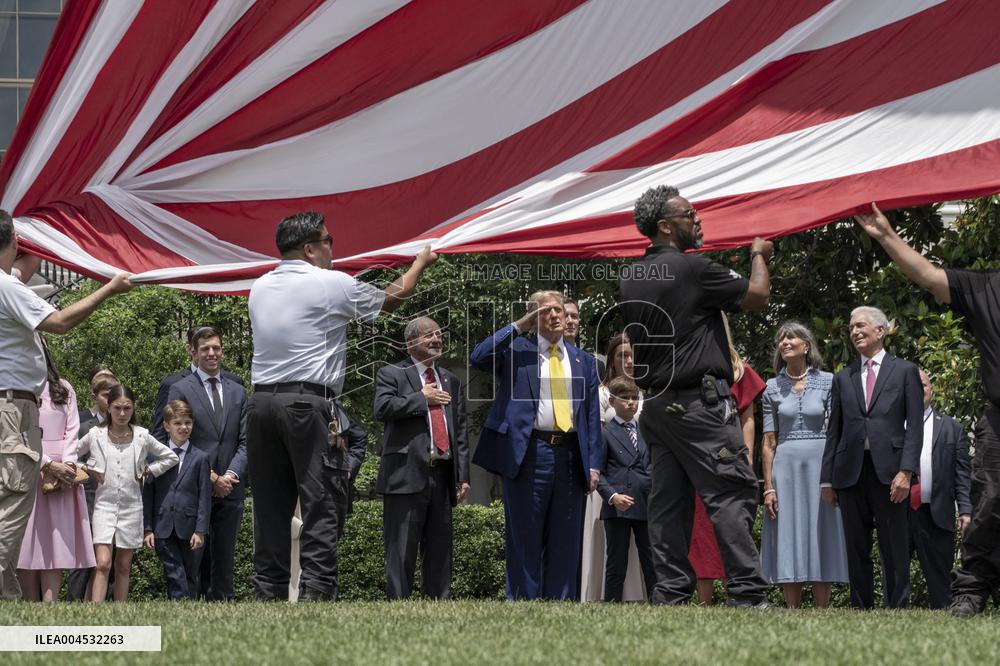 U.S. President Donald Trump Watches as the American Flag is Raised ont he South Lawn