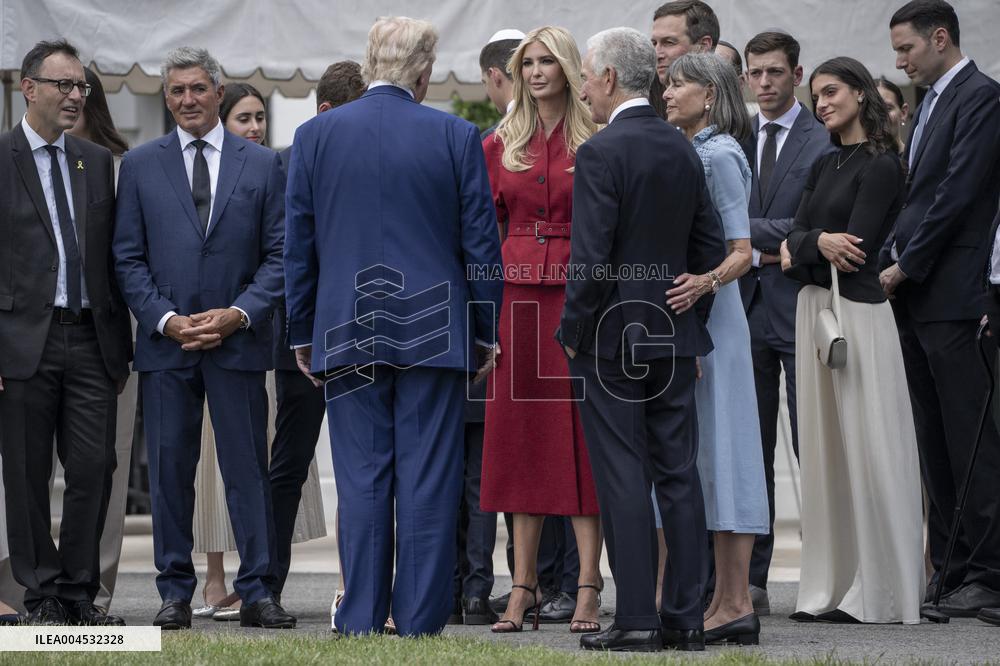 U.S. President Donald Trump Watches as the American Flag is Raised ont he South Lawn