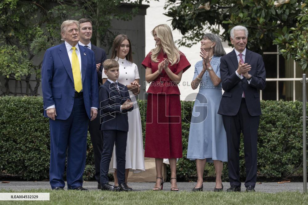 U.S. President Donald Trump Watches as the American Flag is Raised ont he South Lawn