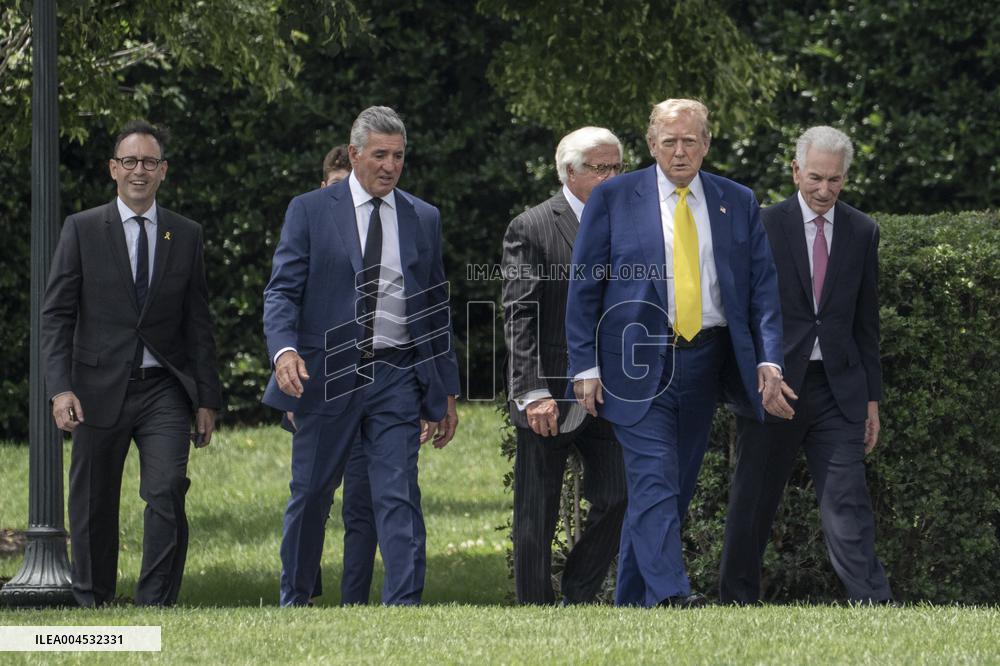 U.S. President Donald Trump Watches as the American Flag is Raised ont he South Lawn