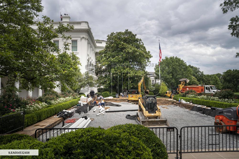 Workers reconstruct the Rose Garden from grass to pavement at White House