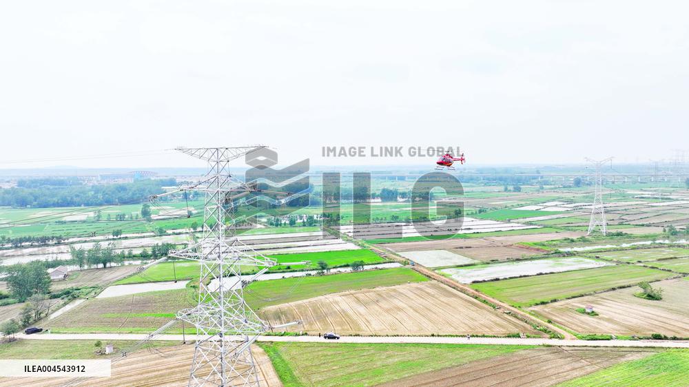 Helicopters Conduct Aerial Patrols on Ultra-high Voltage Transmission Lines