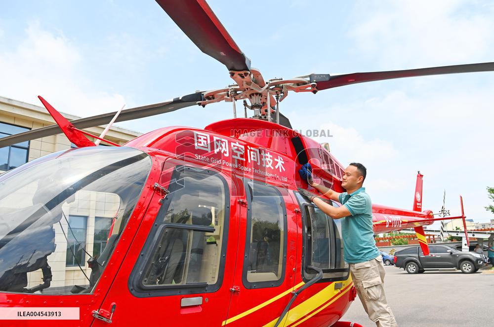 Helicopters Conduct Aerial Patrols on Ultra-high Voltage Transmission Lines