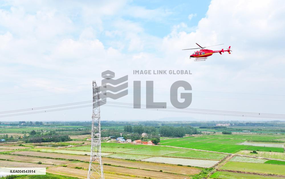 Helicopters Conduct Aerial Patrols on Ultra-high Voltage Transmission Lines