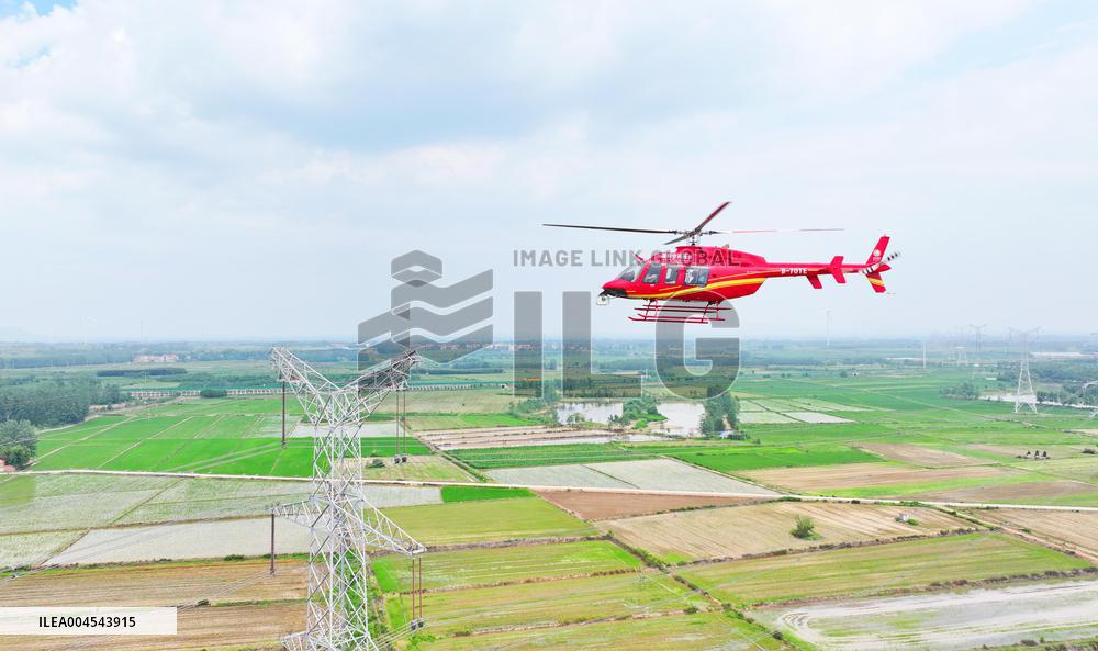 Helicopters Conduct Aerial Patrols on Ultra-high Voltage Transmission Lines