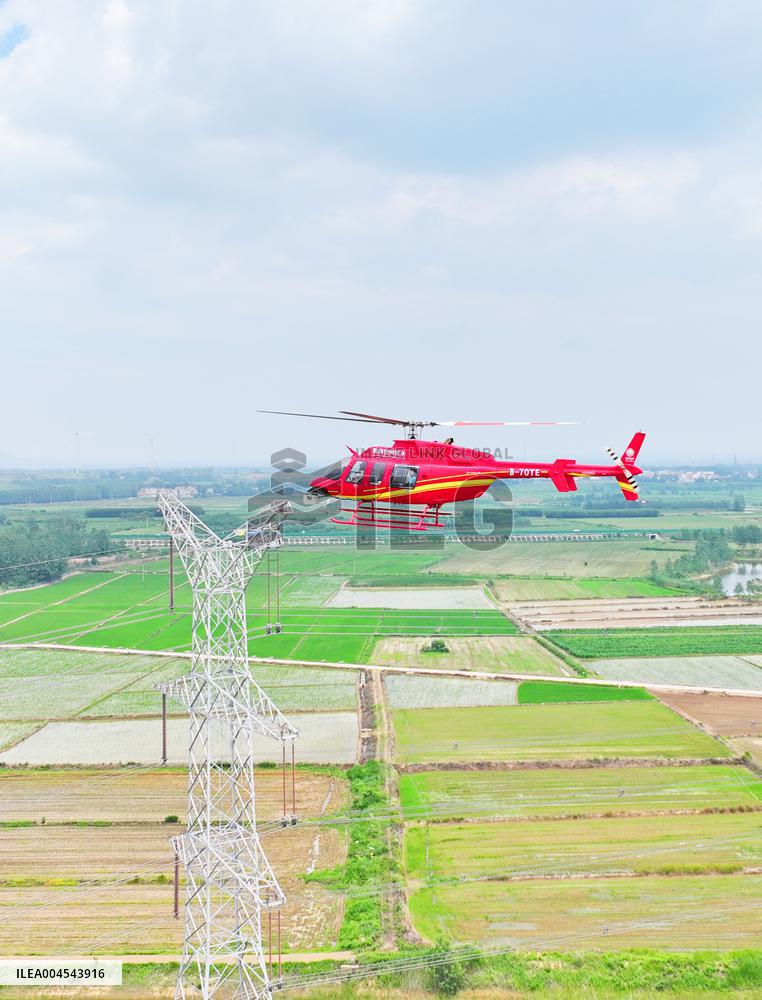 Helicopters Conduct Aerial Patrols on Ultra-high Voltage Transmission Lines