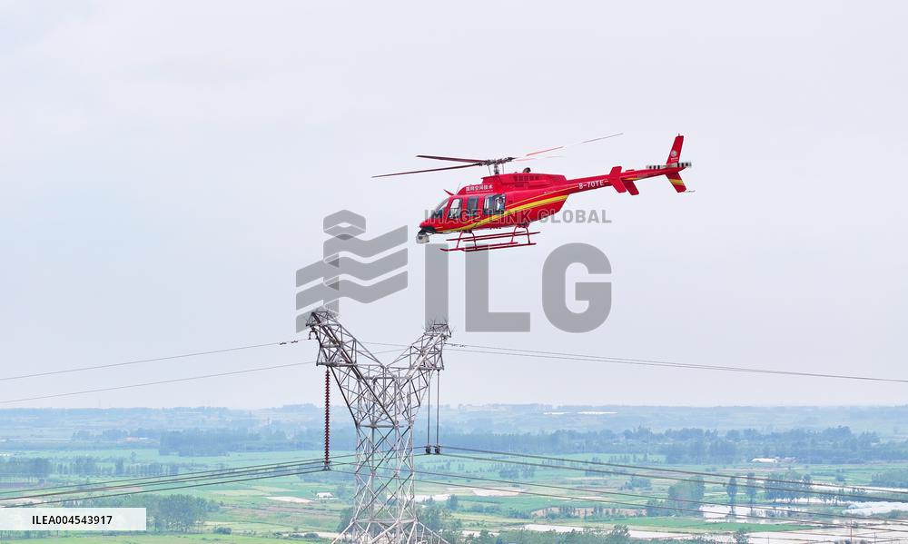 Helicopters Conduct Aerial Patrols on Ultra-high Voltage Transmission Lines