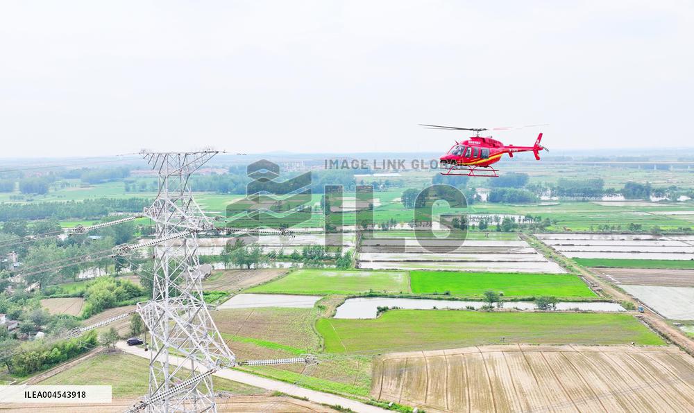 Helicopters Conduct Aerial Patrols on Ultra-high Voltage Transmission Lines