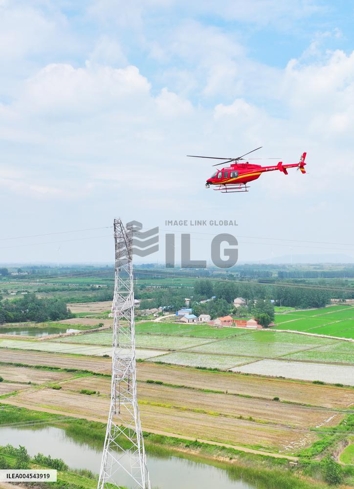 Helicopters Conduct Aerial Patrols on Ultra-high Voltage Transmission Lines