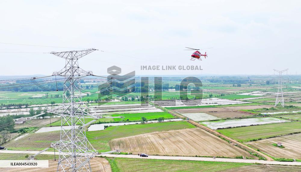 Helicopters Conduct Aerial Patrols on Ultra-high Voltage Transmission Lines