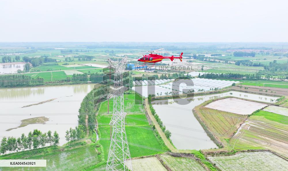 Helicopters Conduct Aerial Patrols on Ultra-high Voltage Transmission Lines