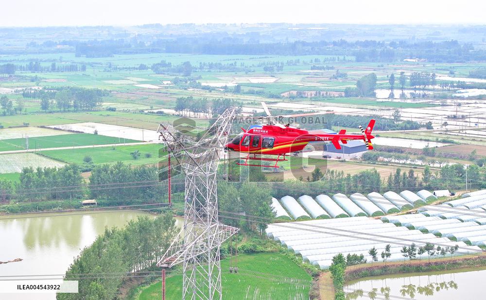 Helicopters Conduct Aerial Patrols on Ultra-high Voltage Transmission Lines