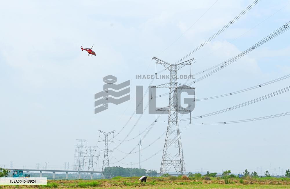 Helicopters Conduct Aerial Patrols on Ultra-high Voltage Transmission Lines