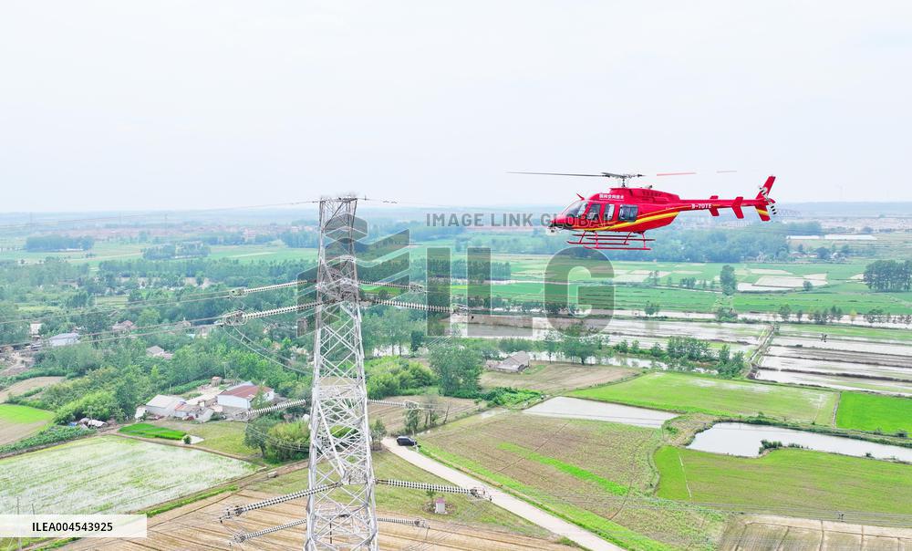 Helicopters Conduct Aerial Patrols on Ultra-high Voltage Transmission Lines