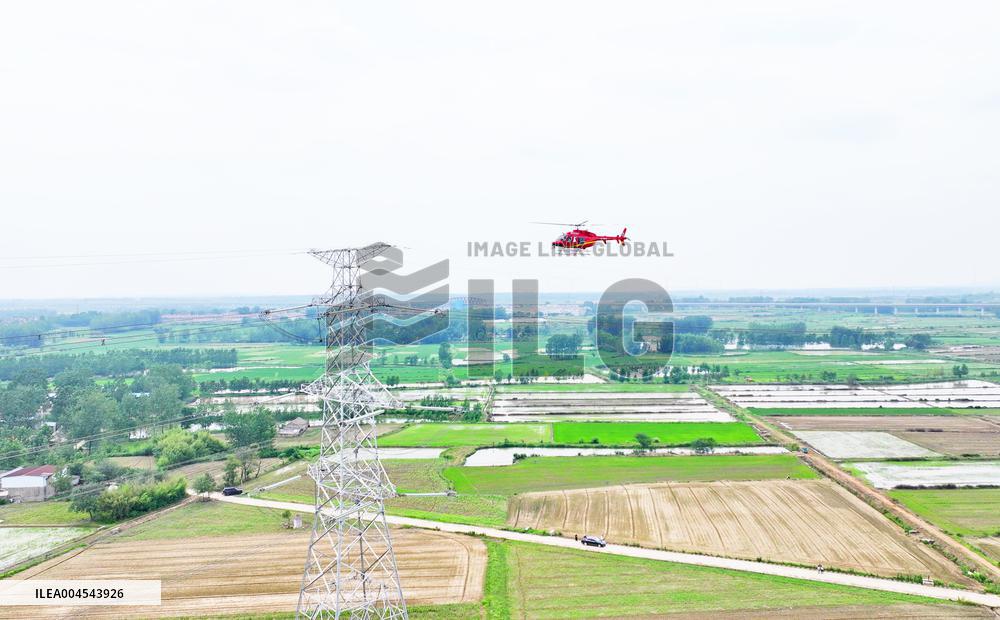 Helicopters Conduct Aerial Patrols on Ultra-high Voltage Transmission Lines
