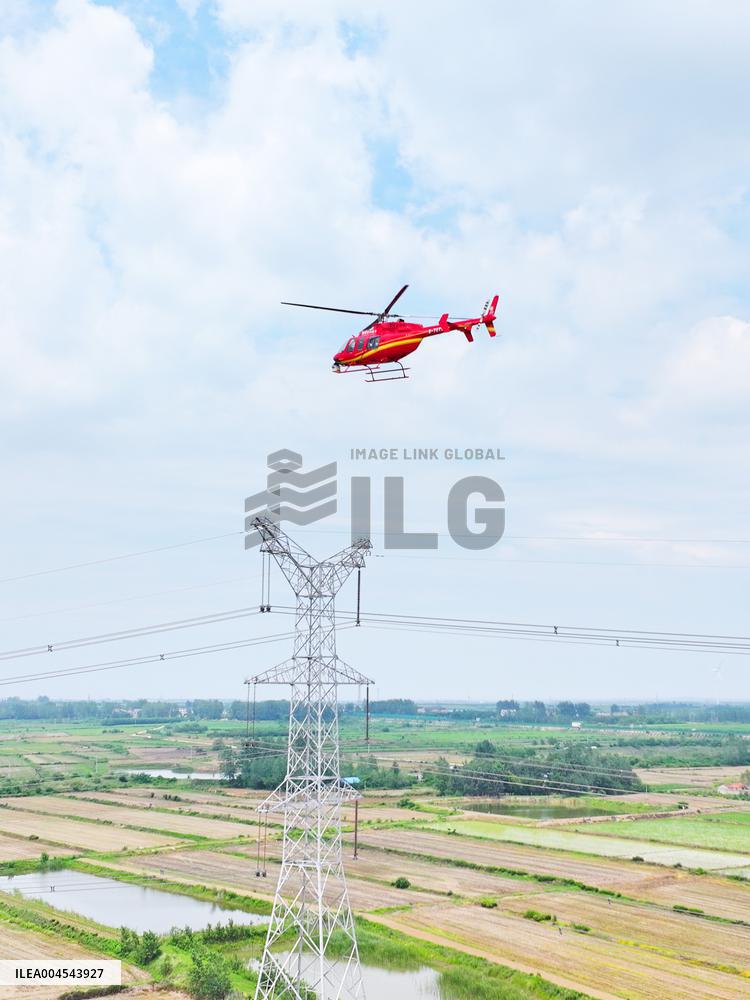 Helicopters Conduct Aerial Patrols on Ultra-high Voltage Transmission Lines