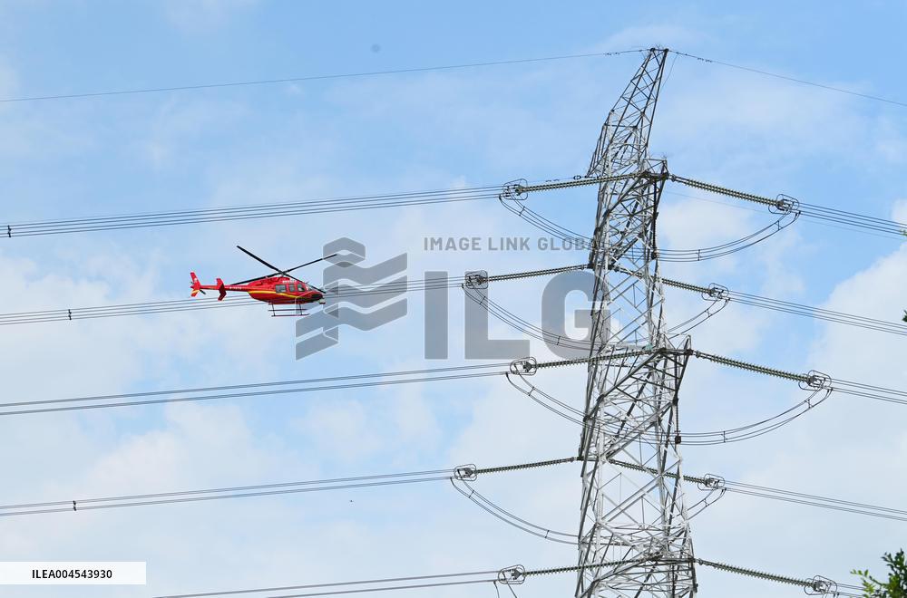 Helicopters Conduct Aerial Patrols on Ultra-high Voltage Transmission Lines