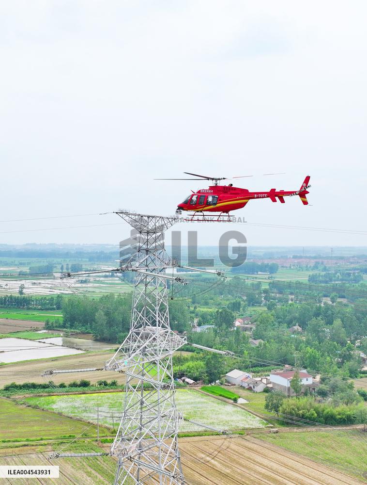 Helicopters Conduct Aerial Patrols on Ultra-high Voltage Transmission Lines