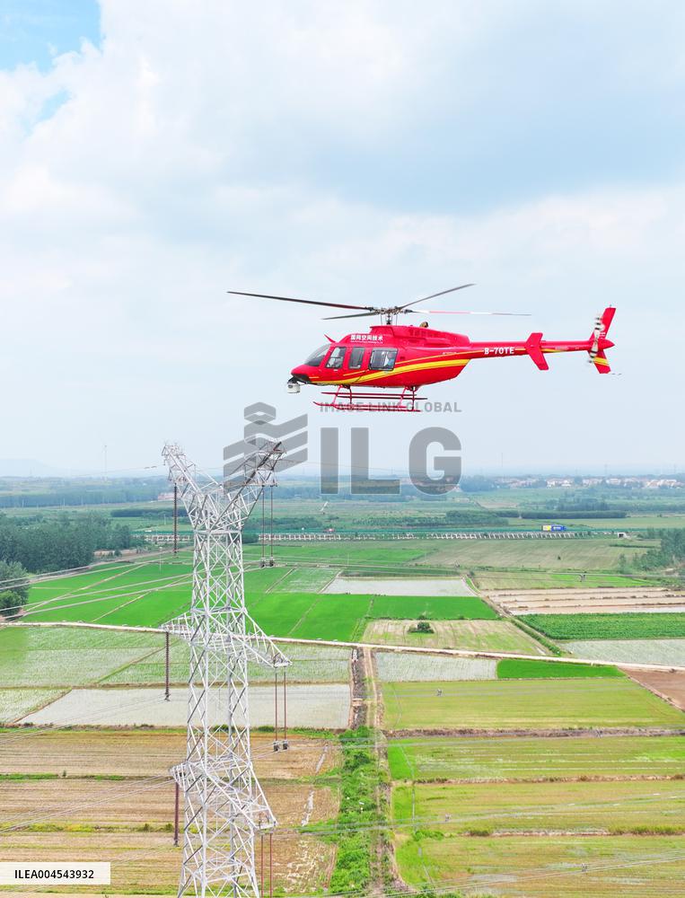 Helicopters Conduct Aerial Patrols on Ultra-high Voltage Transmission Lines