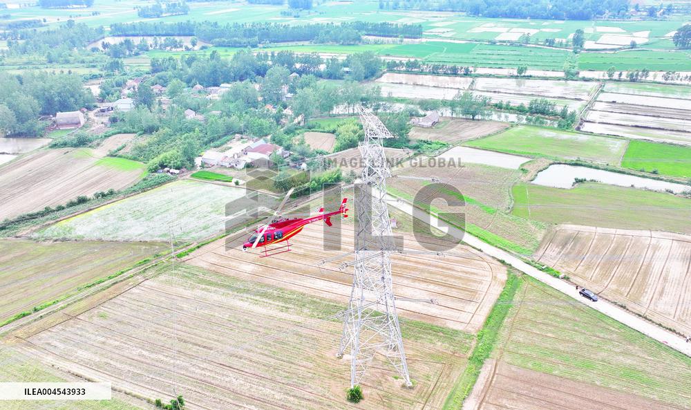 Helicopters Conduct Aerial Patrols on Ultra-high Voltage Transmission Lines