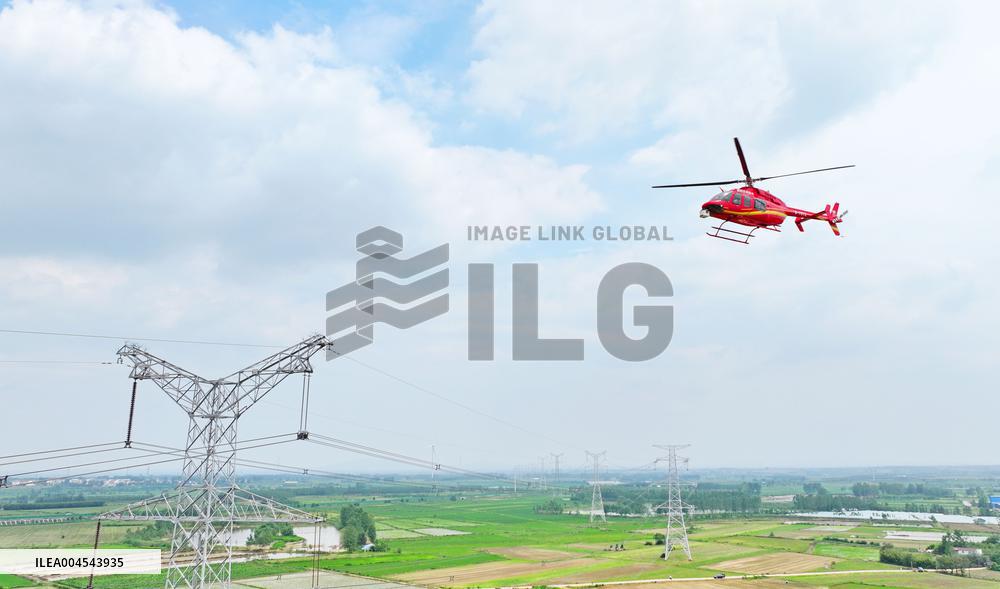 Helicopters Conduct Aerial Patrols on Ultra-high Voltage Transmission Lines