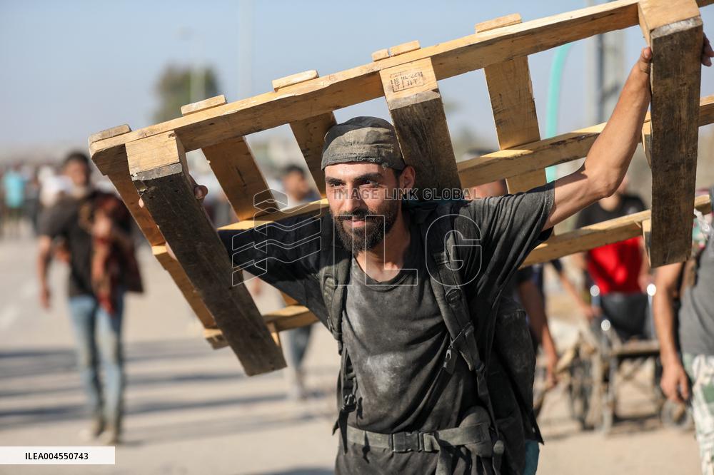 Palestinians Carry Collected Tree Branches and Scrap Wood - Gaza