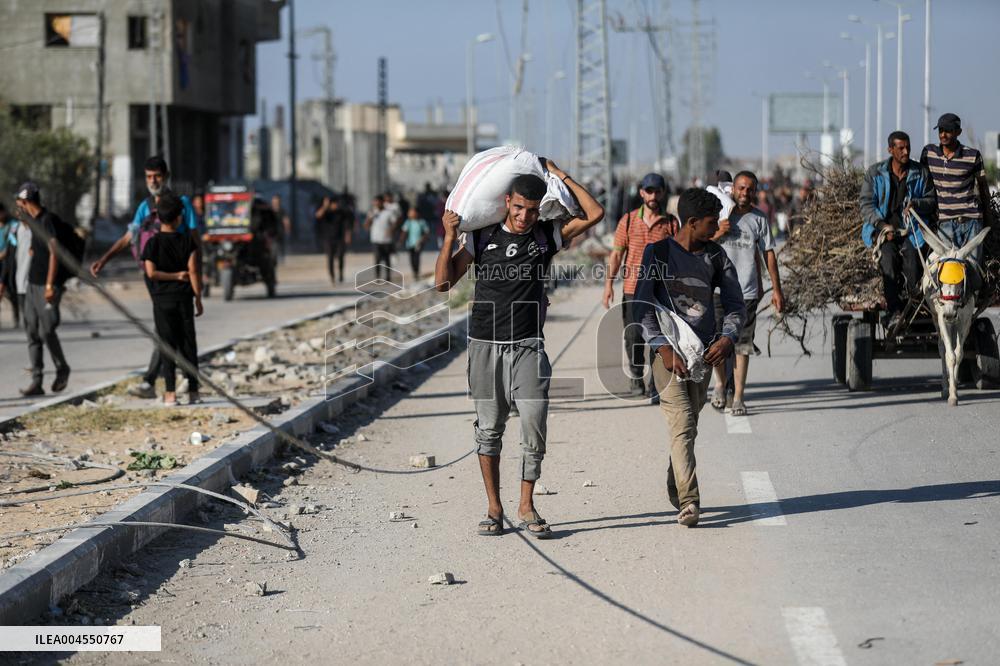 Palestinians Carry Collected Tree Branches and Scrap Wood - Gaza