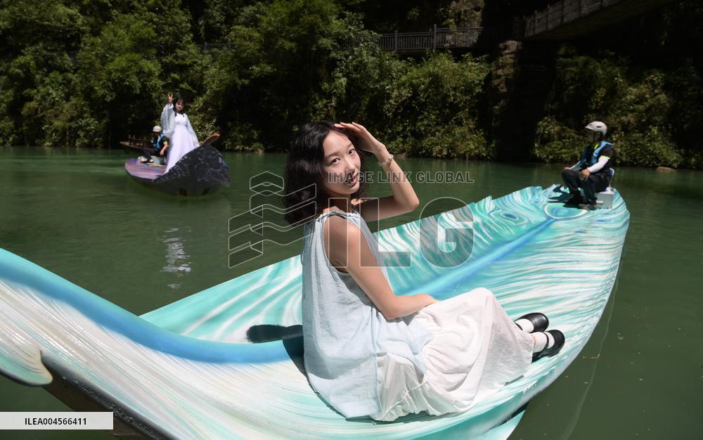 Tourists Take Feather-Shaped Boats - China