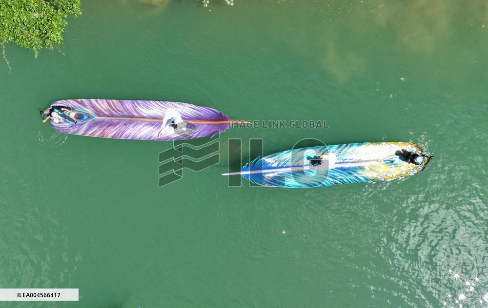 Tourists Take Feather-Shaped Boats - China