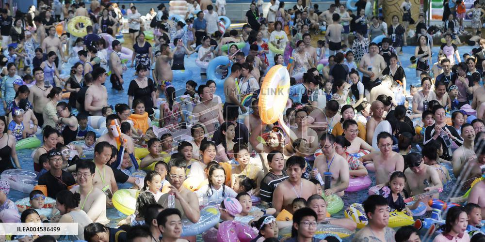 Tourists Enjoy Coolness in Water Park