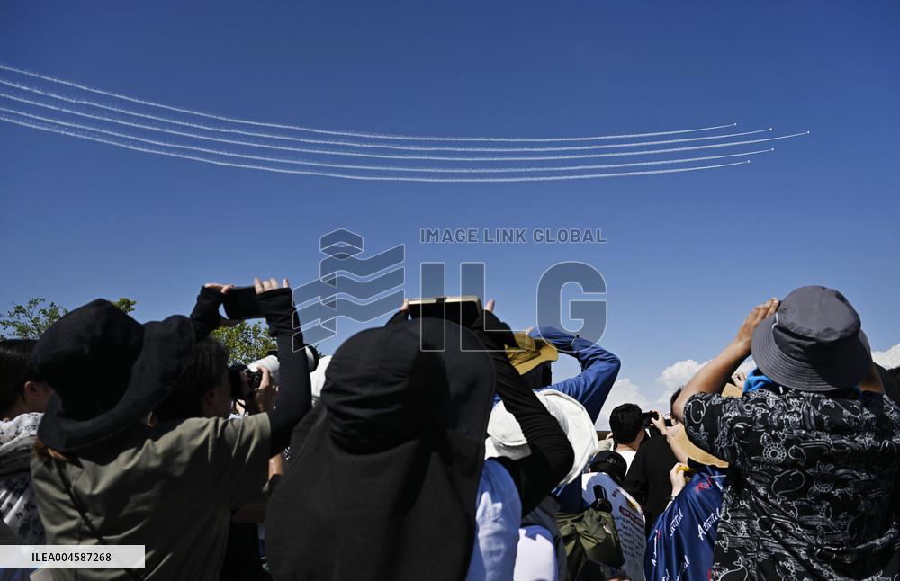 Blue Impulse aerobatic team flies over Osaka