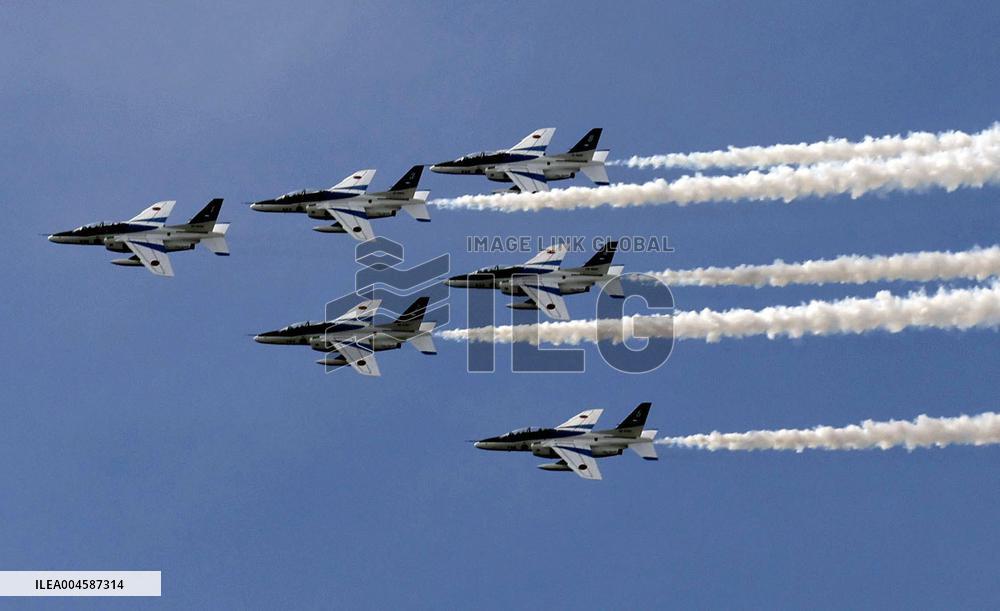 Blue Impulse aerobatic team flies over Osaka