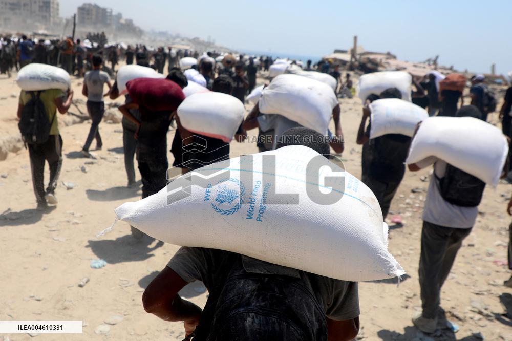 Palestinians Carry Flour As Humanitarian Aid Reaches Gaza