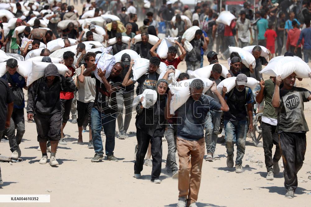 Palestinians Carry Flour As Humanitarian Aid Reaches Gaza