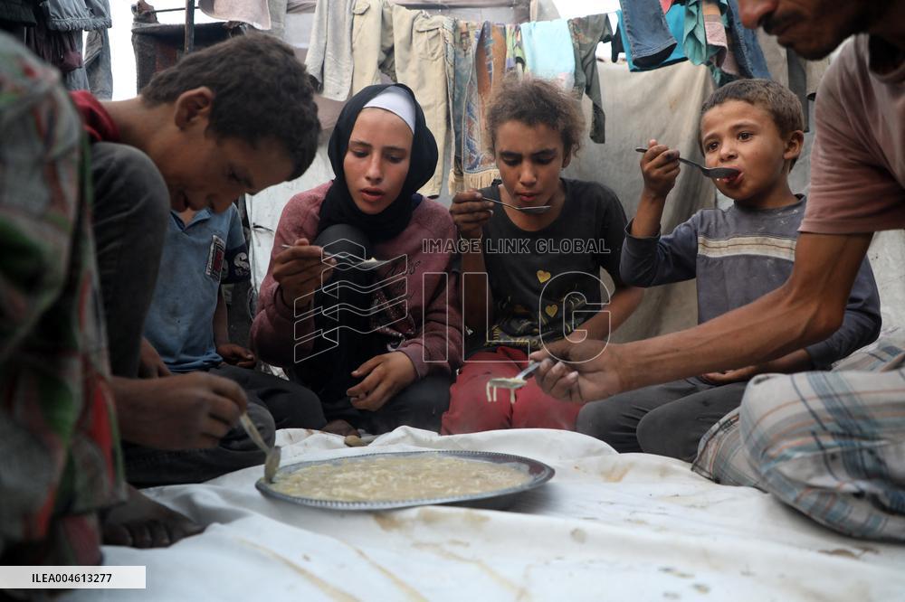 Displaced Family Prepares Meal Amid Food Shortages - Gaza City