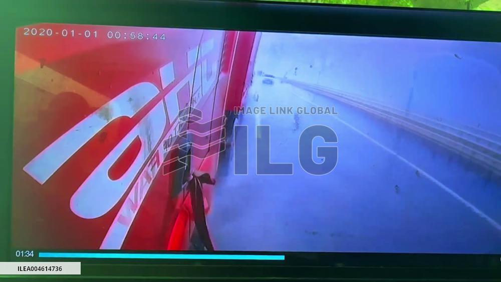 China: Truck Swerves Out of Control During Rainstorm, Narrowly Misses Car