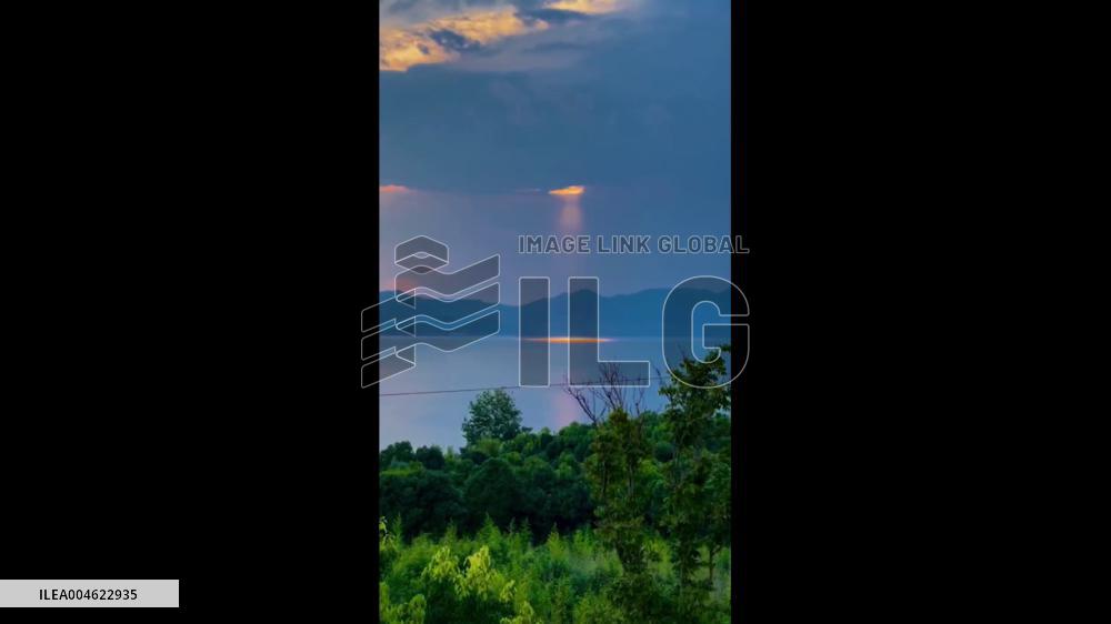 China: Golden Sunbeams Break Through Clouds Over Lake Fuxian in Yuxi