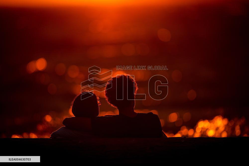 Illustration - Silhouetted at Sunset Amidst Vancouver Island Wildfires - Canada