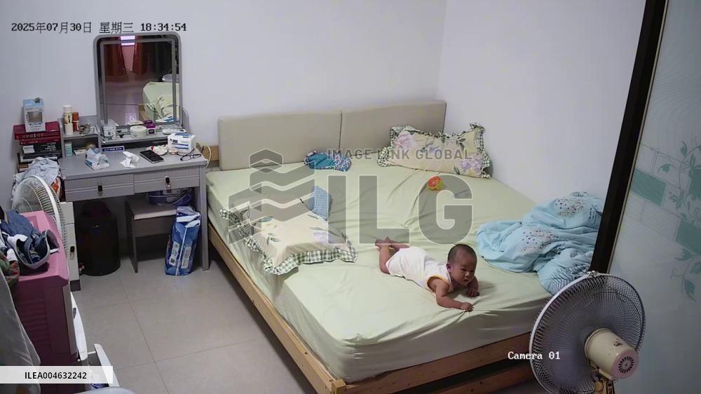 China: Grandfather Leaps to Catch Baby Seconds Before Falling off Bed