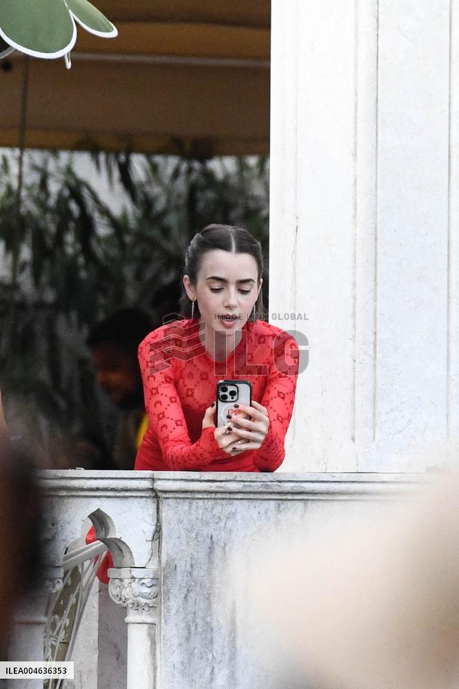 Lily Collins Takes a FaceTime Break during Emily in Paris Set - Venice