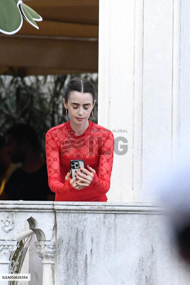 Lily Collins Takes a FaceTime Break during Emily in Paris Set - Venice