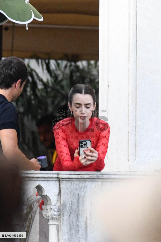 Lily Collins Takes a FaceTime Break during Emily in Paris Set - Venice