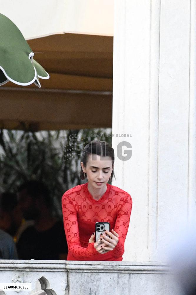 Lily Collins Takes a FaceTime Break during Emily in Paris Set - Venice