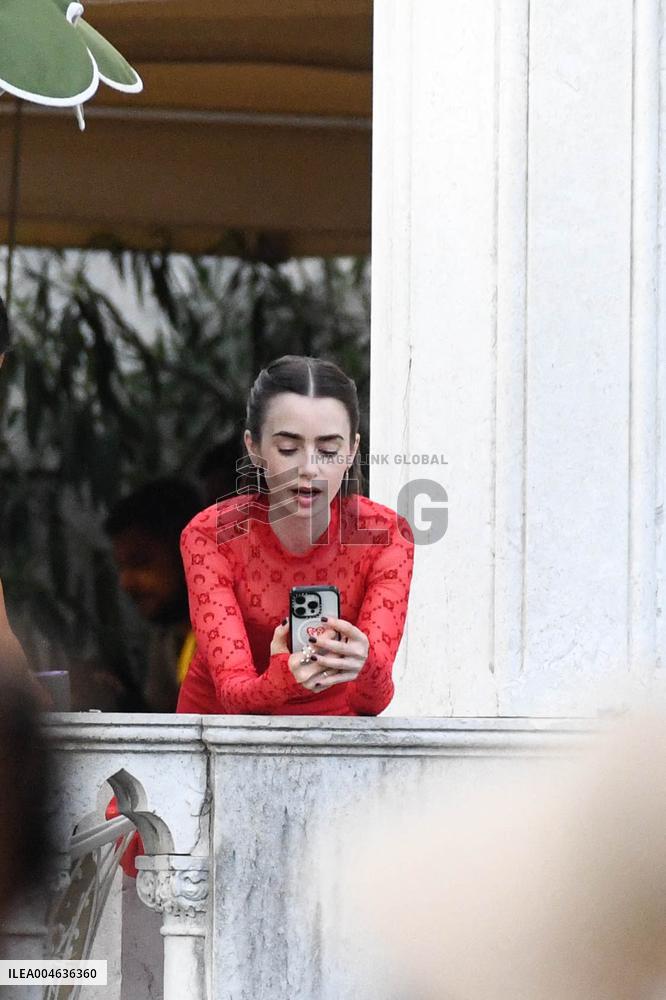 Lily Collins Takes a FaceTime Break during Emily in Paris Set - Venice