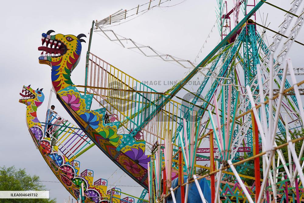 A Labourer Works on A Giant Ferris Wheel - India